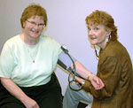 Assistant Secretary (and registered nurse) Patty Hayes checks blood pressure for Secretary of Health Mary Selecky